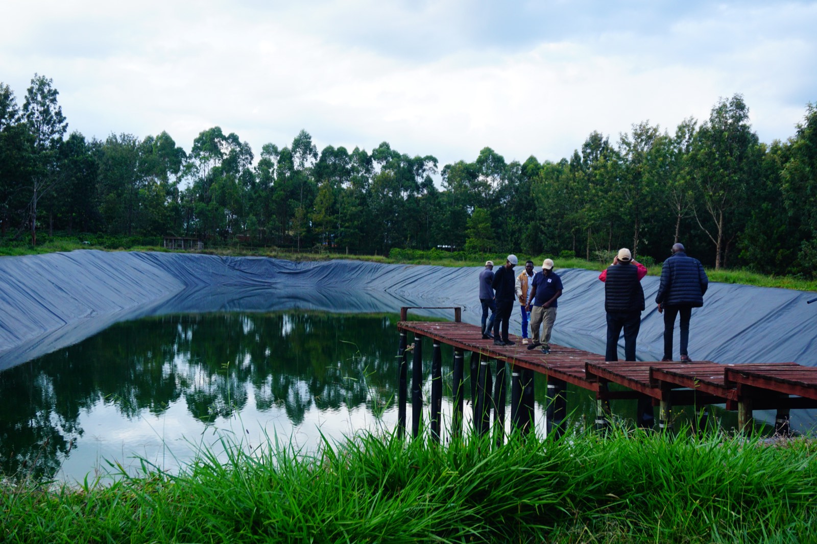 Members touring a farm reservoir on a company visit during the Kitale trip